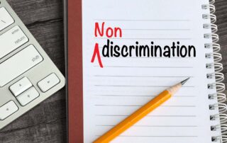 A GSA notebook with the word non discrimination prominently displayed next to a keyboard for Federal Government proposal support.