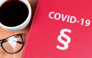 A coffee table book featuring the word covid-19 alongside a cup of coffee.